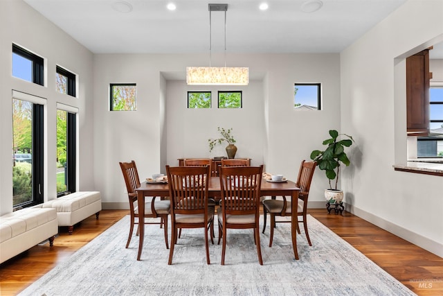 dining room with recessed lighting, baseboards, and wood finished floors