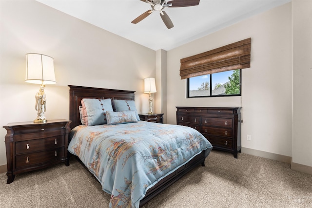 carpeted bedroom featuring baseboards and ceiling fan