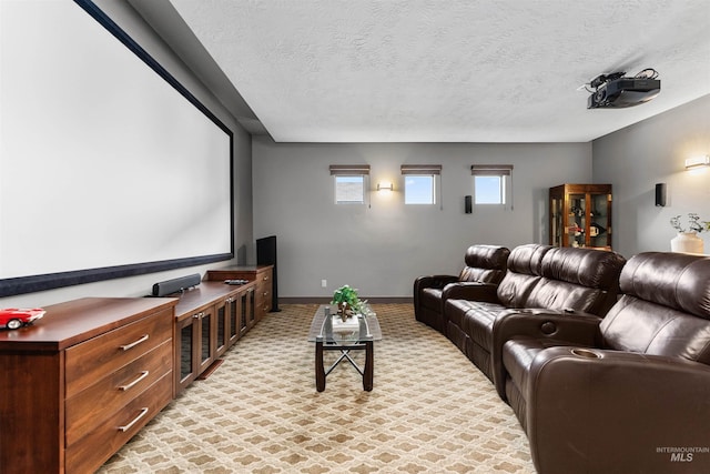 cinema with baseboards, a textured ceiling, and light colored carpet