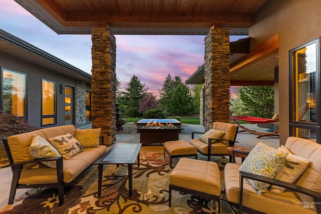 view of patio / terrace with an outdoor living space with a fire pit