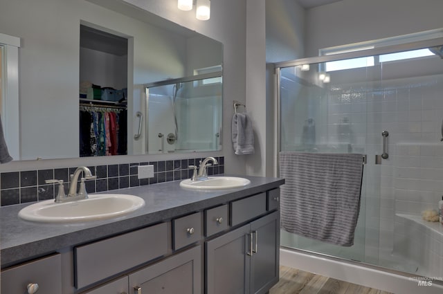 6240 W Black Butte St, Meridian, ID 83646 - full bathroom with a sink, a walk in closet, a shower stall, and tasteful backsplash