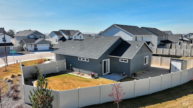 6240 W Black Butte St, Meridian, ID 83646 - exterior space featuring a fenced backyard, a residential view, a yard, and roof with shingles