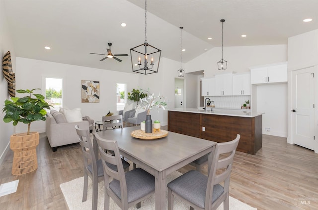 2117 Oxon St, Caldwell, ID 83605 - dining area featuring light wood-style flooring, a chandelier, ceiling fan, recessed lighting, and high vaulted ceiling