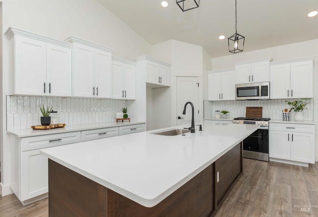 2117 Oxon St, Caldwell, ID 83605 - kitchen with appliances with stainless steel finishes, tasteful backsplash, recessed lighting, white cabinetry, and light countertops