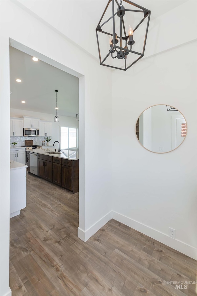 2117 Oxon St, Caldwell, ID 83605 - unfurnished dining area with a chandelier, wood finished floors, and recessed lighting