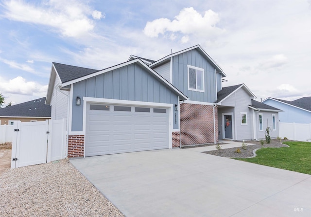 2117 Oxon St, Caldwell, ID 83605 - view of front of property featuring board and batten siding, brick siding, a garage, a gate, and driveway