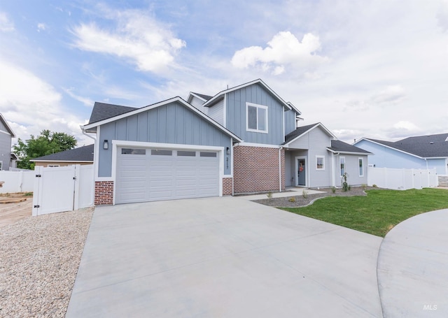 2117 Oxon St, Caldwell, ID 83605 - view of front of house with board and batten siding, a garage, driveway, a gate, and brick siding