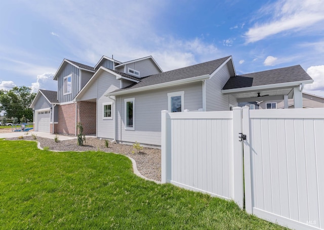 2117 Oxon St, Caldwell, ID 83605 - view of home's exterior featuring a gate, an attached garage, and roof with shingles