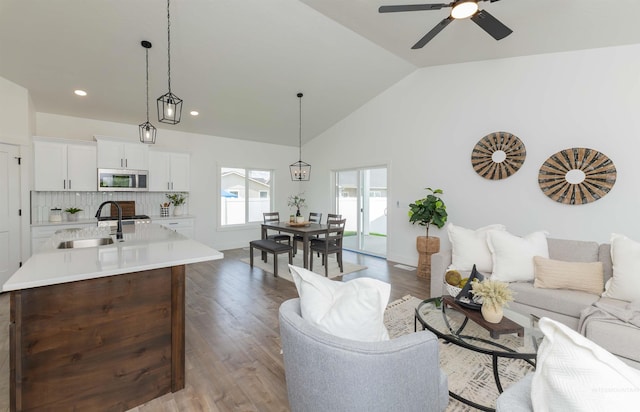 2117 Oxon St, Caldwell, ID 83605 - living room with vaulted ceiling, ceiling fan, wood finished floors, and recessed lighting