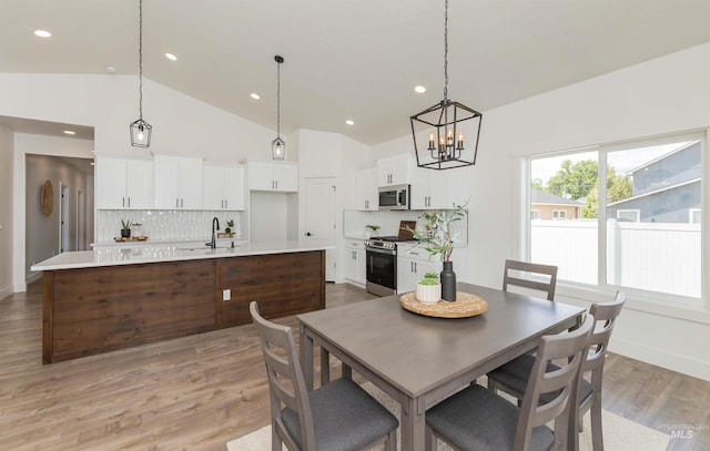 2117 Oxon St, Caldwell, ID 83605 - dining area featuring lofted ceiling, a chandelier, recessed lighting, and light wood-style floors