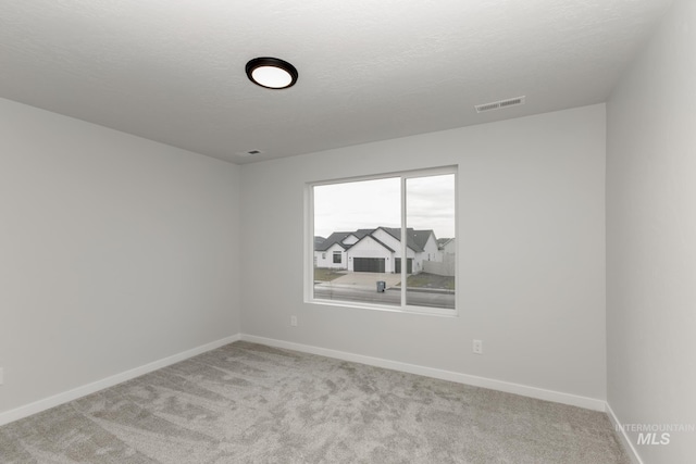 14761 N Ninja Way, Nampa, ID 83651 - unfurnished room with a textured ceiling, baseboards, visible vents, and light carpet