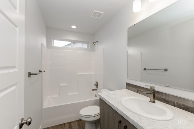 14761 N Ninja Way, Nampa, ID 83651 - full bathroom featuring visible vents, toilet, wood finished floors, washtub / shower combination, and vanity