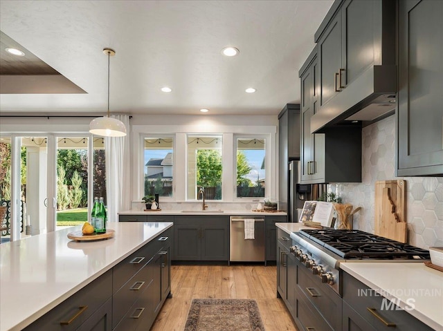 kitchen with light countertops, appliances with stainless steel finishes, recessed lighting, and a sink