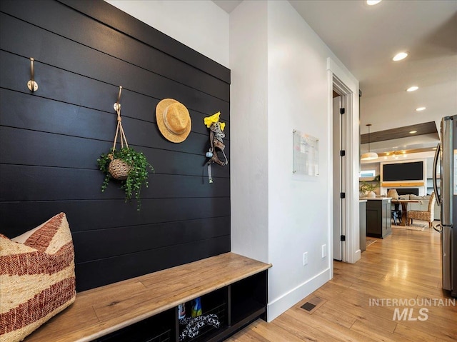mudroom with light wood-type flooring, baseboards, recessed lighting, and visible vents