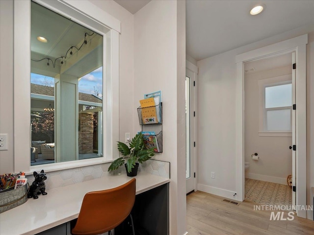 home office with recessed lighting, light wood-style flooring, visible vents, and baseboards