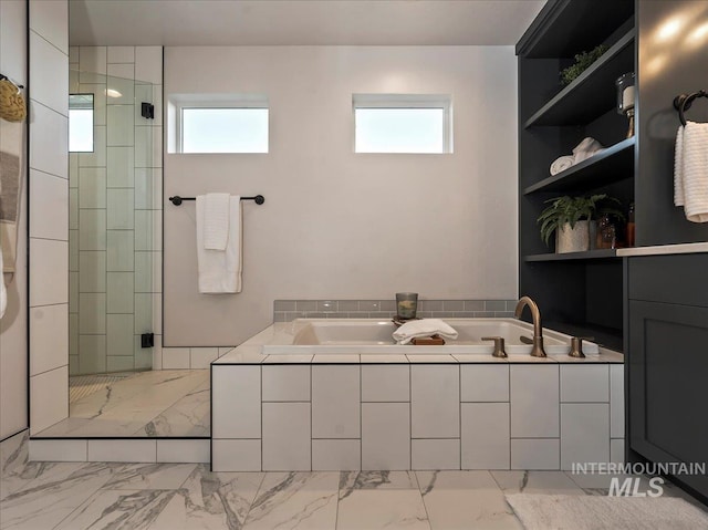 full bath featuring a garden tub, marble finish floor, and a shower stall