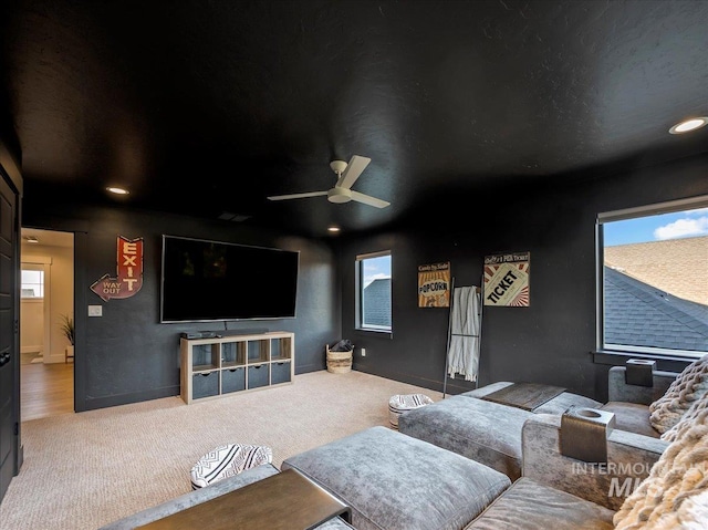 carpeted cinema room featuring recessed lighting, a wealth of natural light, and a ceiling fan