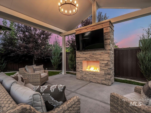 view of patio featuring a fenced backyard and an outdoor living space with a fireplace