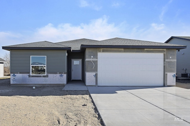 view of front of house featuring central AC unit and a garage