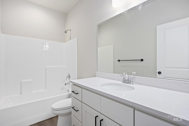 full bathroom featuring hardwood / wood-style flooring, toilet, bathtub / shower combination, and vanity