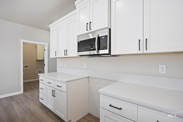 kitchen with white cabinets and hardwood / wood-style flooring