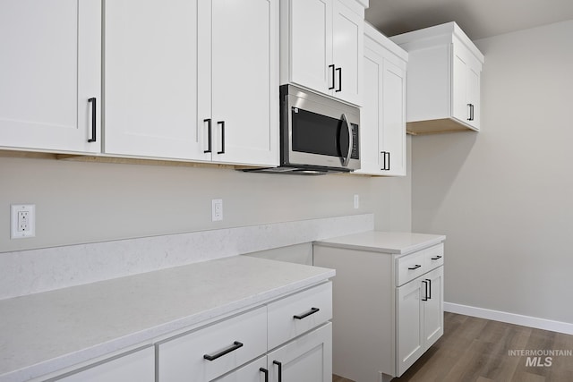 kitchen with white cabinets and dark hardwood / wood-style floors