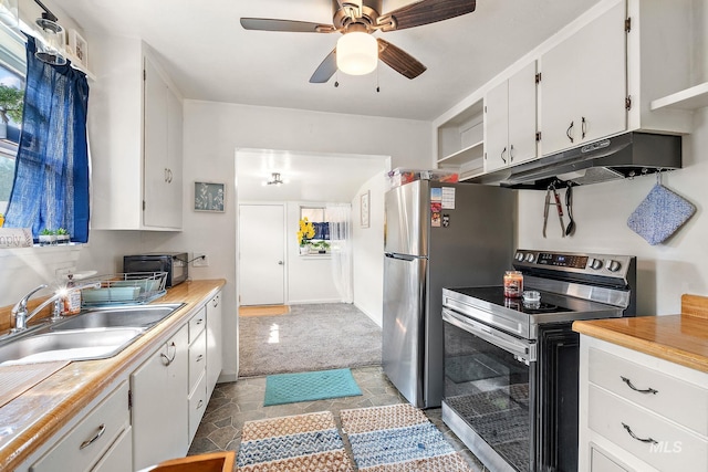 kitchen featuring ceiling fan, sink, electric stove, and white cabinets