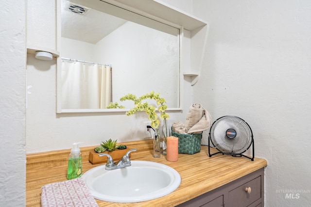 bathroom featuring vanity and curtained shower