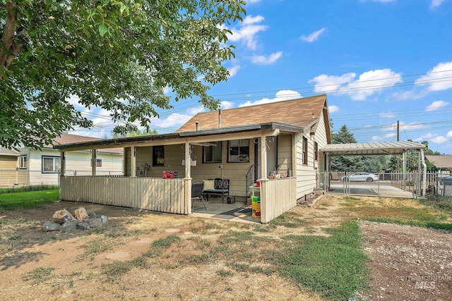 rear view of property with a carport