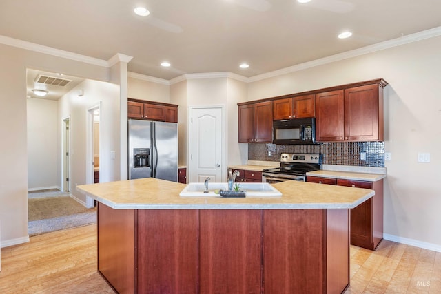 kitchen with crown molding, light wood-type flooring, an island with sink, and appliances with stainless steel finishes