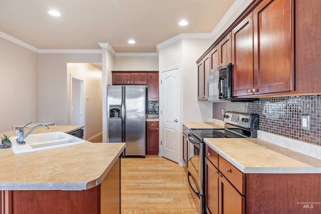kitchen featuring crown molding, sink, stainless steel appliances, and light wood-type flooring
