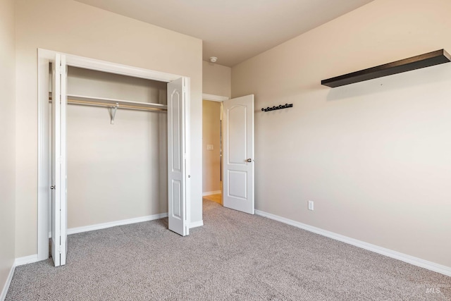 unfurnished bedroom featuring a closet and carpet