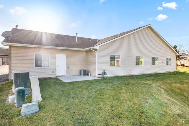 rear view of house featuring a patio, central AC unit, and a lawn