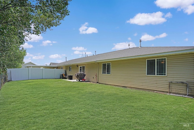 back of house with a yard