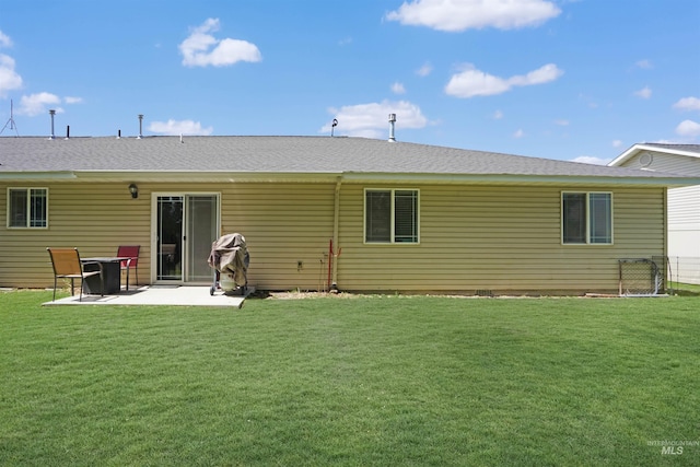 rear view of house with a yard and a patio area