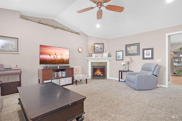 carpeted living room featuring ceiling fan, lofted ceiling, and a fireplace