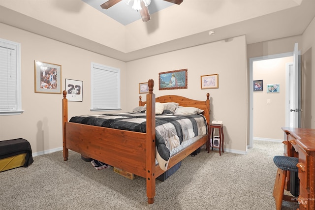 bedroom featuring ceiling fan, carpet flooring, and a raised ceiling