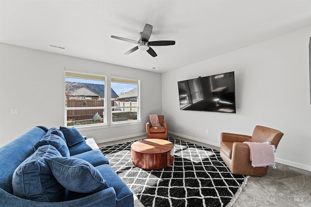 living room with ceiling fan and carpet