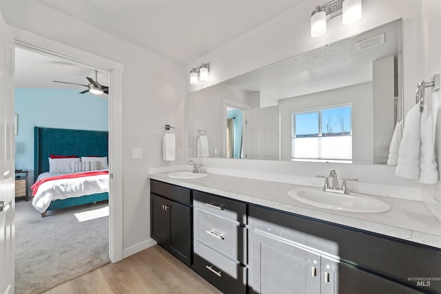 bathroom featuring vanity, hardwood / wood-style floors, and ceiling fan