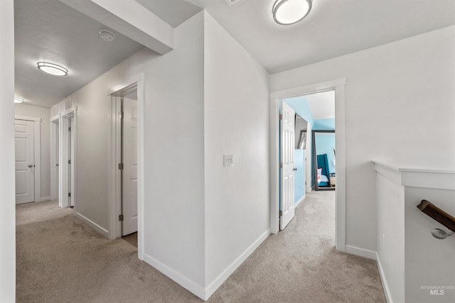 corridor with light colored carpet