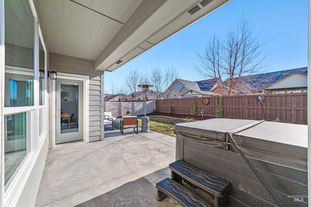 view of patio / terrace with a hot tub