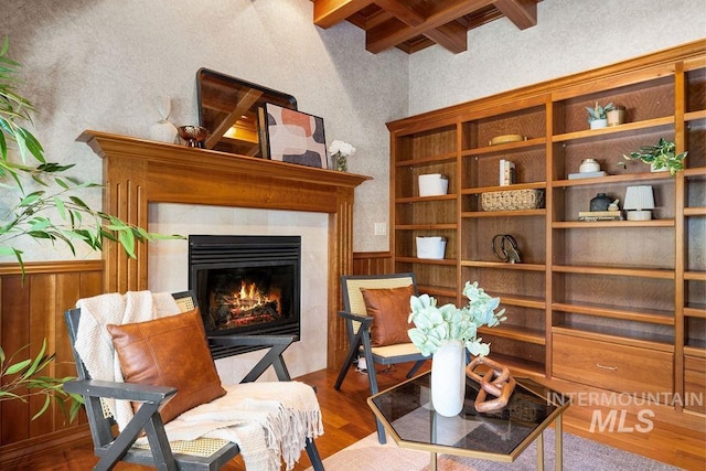 4553 N Arrow Crest Way, Boise, ID 83703 - sitting room featuring beam ceiling, a glass covered fireplace, wainscoting, wood finished floors, and a textured wall
