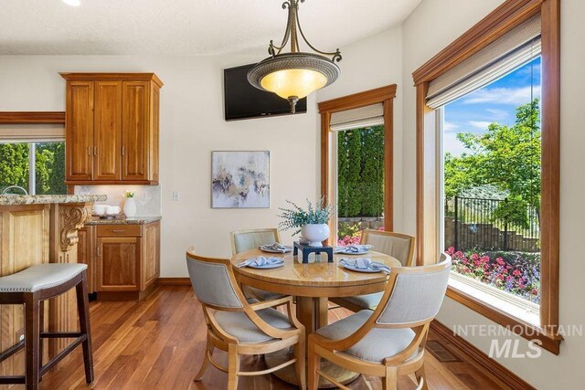 4553 N Arrow Crest Way, Boise, ID 83703 - dining area featuring light wood-type flooring, healthy amount of natural light, and baseboards