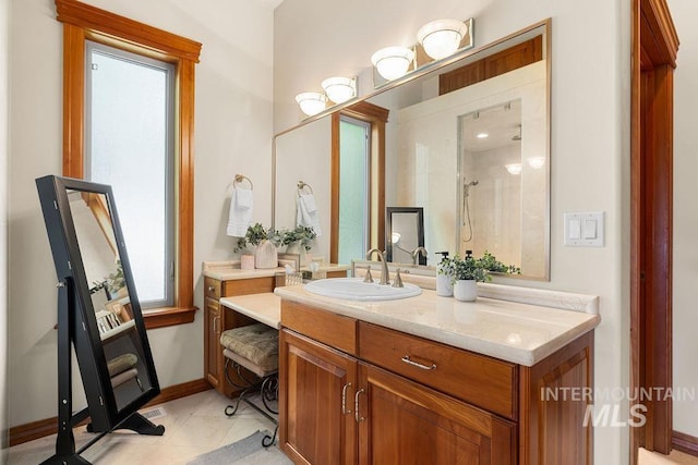 4553 N Arrow Crest Way, Boise, ID 83703 - bathroom with vanity, tiled shower, and baseboards