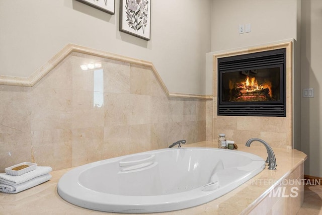 4553 N Arrow Crest Way, Boise, ID 83703 - bathroom with a tub with jets, a glass covered fireplace, and tile walls