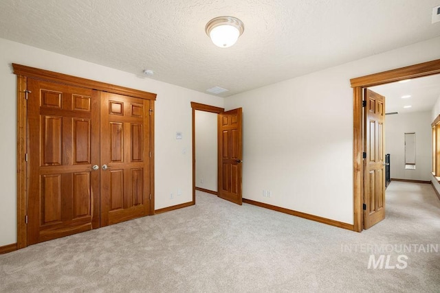 4553 N Arrow Crest Way, Boise, ID 83703 - unfurnished bedroom with light colored carpet, baseboards, a textured ceiling, and a closet
