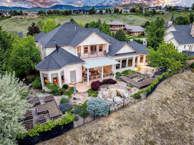 4553 N Arrow Crest Way, Boise, ID 83703 - back of property with a balcony, a vegetable garden, a fenced backyard, a patio area, and roof with shingles
