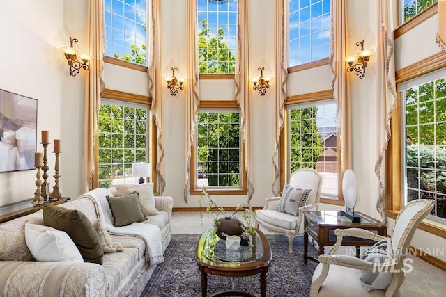 4553 N Arrow Crest Way, Boise, ID 83703 - carpeted living room featuring a high ceiling and baseboards