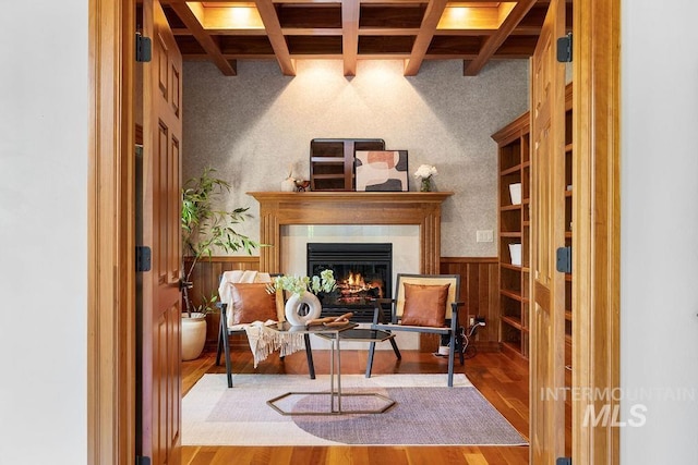 4553 N Arrow Crest Way, Boise, ID 83703 - living area with coffered ceiling, a fireplace, wainscoting, wood finished floors, and beamed ceiling