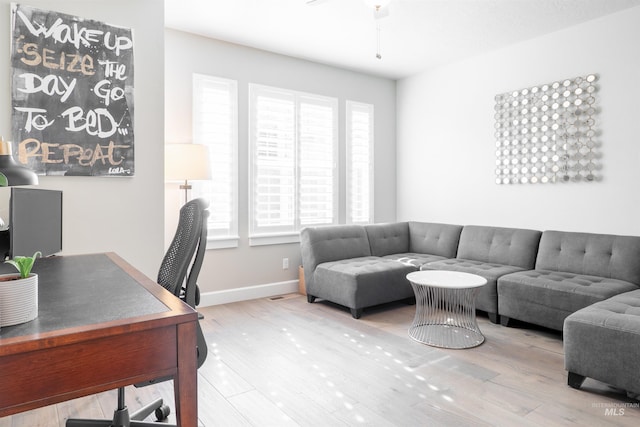 home office with baseboards and wood finished floors